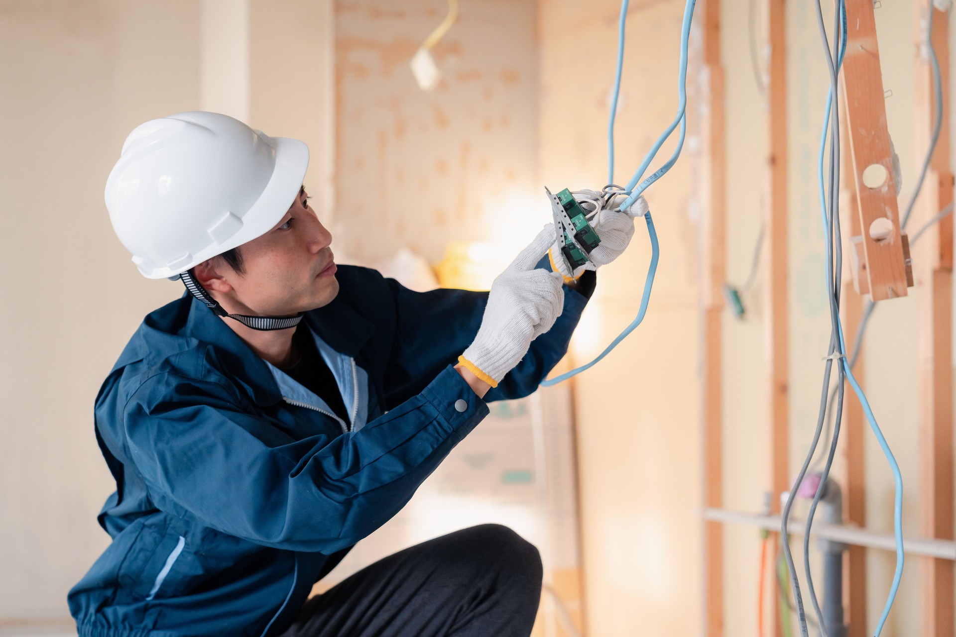Electrician working on wiring at construction site